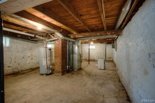 basement featuring heating unit and water heater