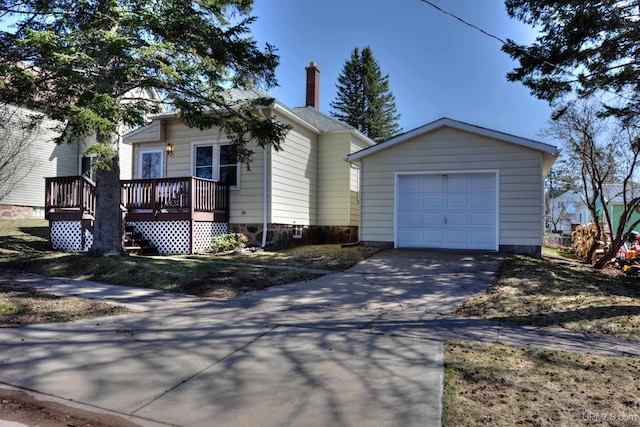 view of front of property with an outdoor structure, concrete driveway, a deck, a chimney, and a garage
