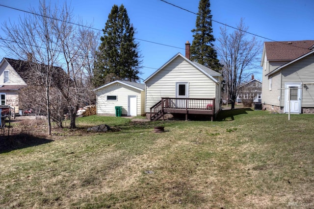 back of house with a lawn, a chimney, and a wooden deck