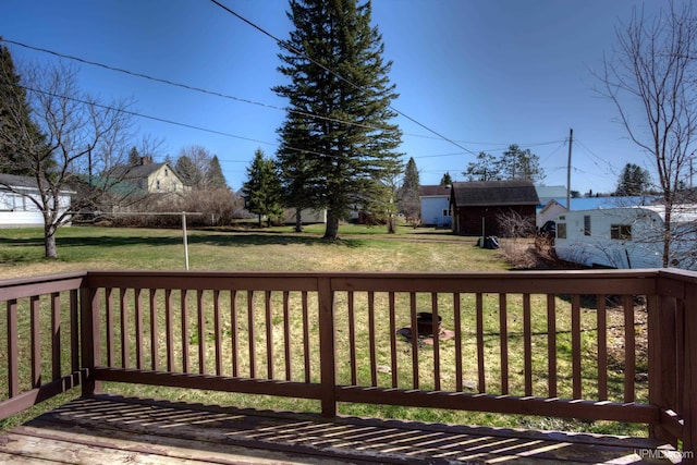 wooden terrace featuring a lawn