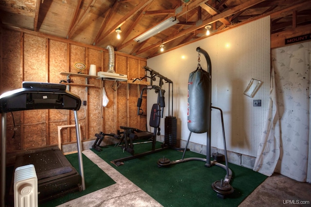 exercise room featuring vaulted ceiling