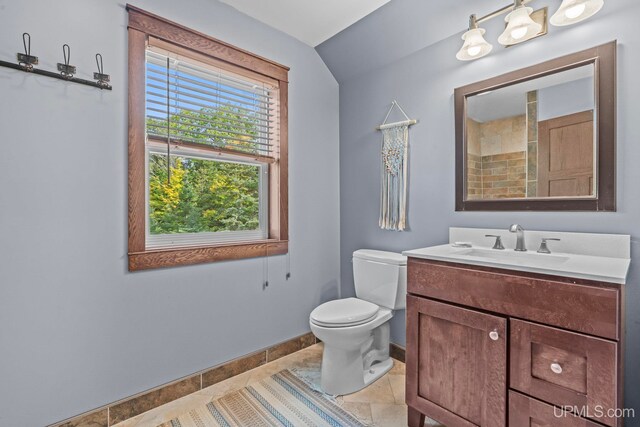 bathroom featuring toilet, tile patterned flooring, vanity, and baseboards