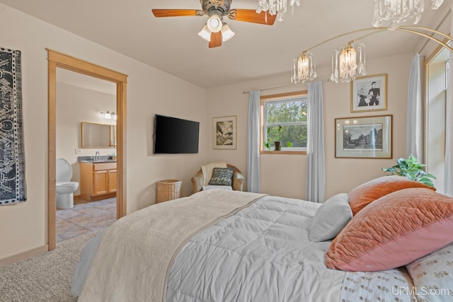bedroom featuring ensuite bathroom, a notable chandelier, light colored carpet, and a sink
