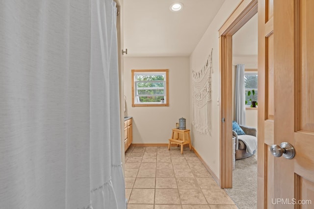 hallway with baseboards and recessed lighting