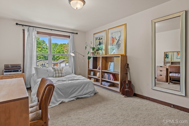 bedroom with carpet flooring and baseboards