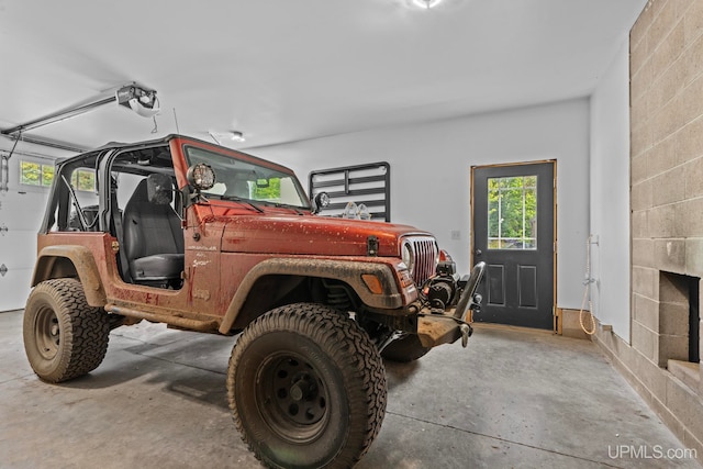 garage with a garage door opener and concrete block wall