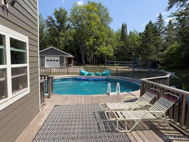 view of pool featuring an outdoor structure and a deck