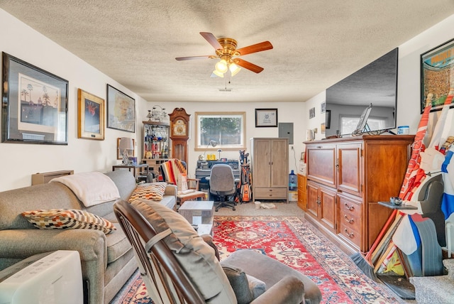 living area featuring a textured ceiling, ceiling fan, and light colored carpet