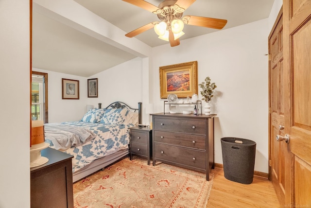bedroom with a ceiling fan and light wood-style floors