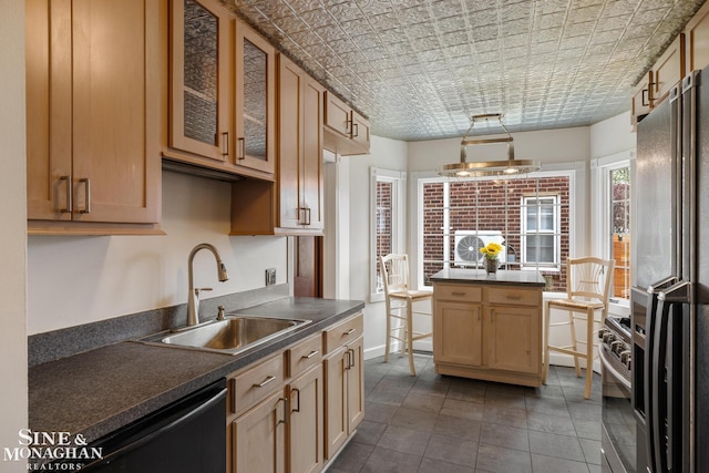 kitchen with glass insert cabinets, a sink, dark countertops, dishwashing machine, and fridge with ice dispenser