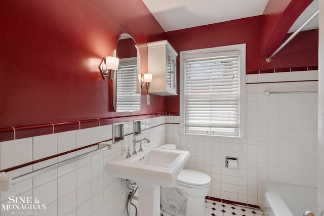 full bath featuring tile walls, walk in shower, toilet, and a bathtub