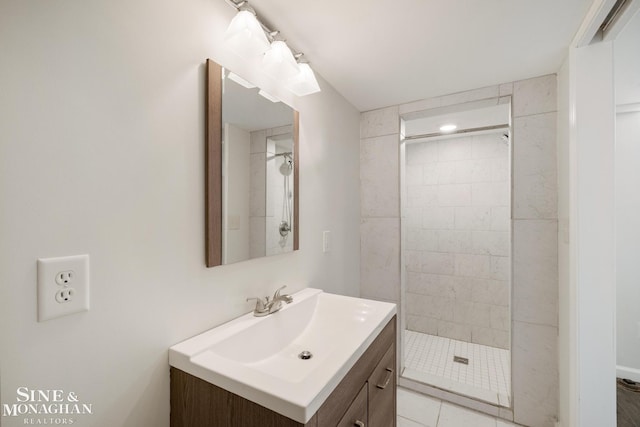 full bath featuring vanity and tiled shower