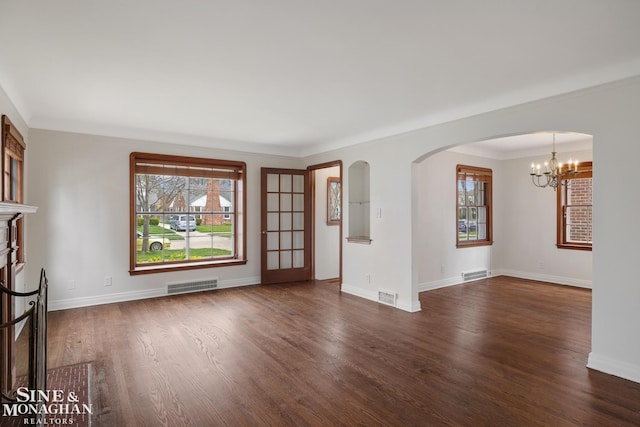 unfurnished room featuring dark wood finished floors, visible vents, and plenty of natural light