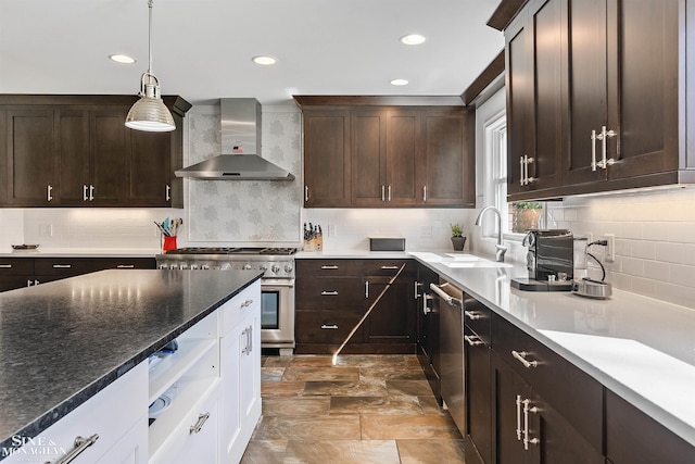 kitchen featuring wall chimney exhaust hood, appliances with stainless steel finishes, backsplash, and dark brown cabinets