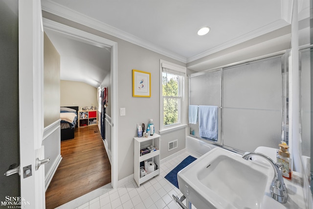 ensuite bathroom featuring crown molding, visible vents, an enclosed shower, tile patterned floors, and a sink