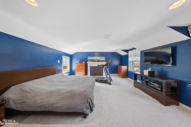 bedroom featuring visible vents, baseboards, vaulted ceiling, and carpet