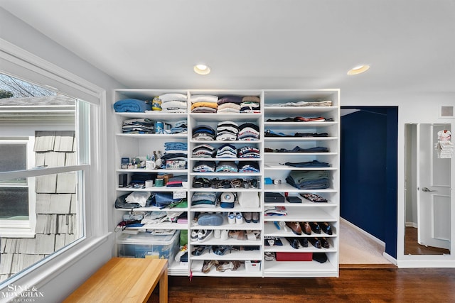spacious closet featuring wood finished floors and visible vents