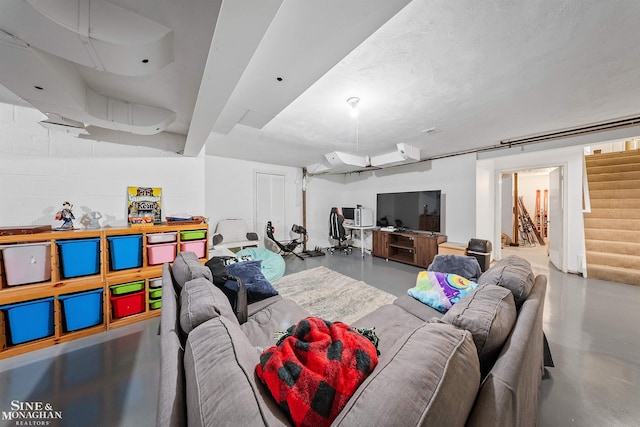 living room with concrete floors and stairs