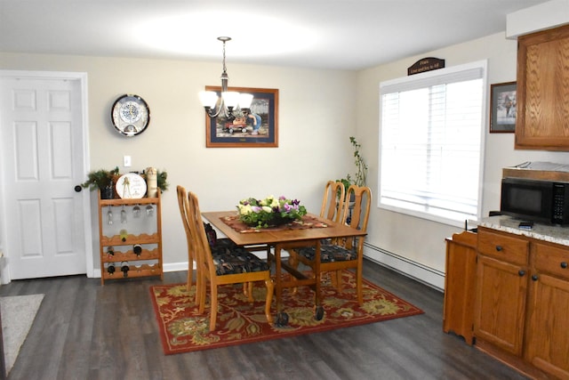 dining area with an inviting chandelier, dark wood finished floors, and baseboard heating