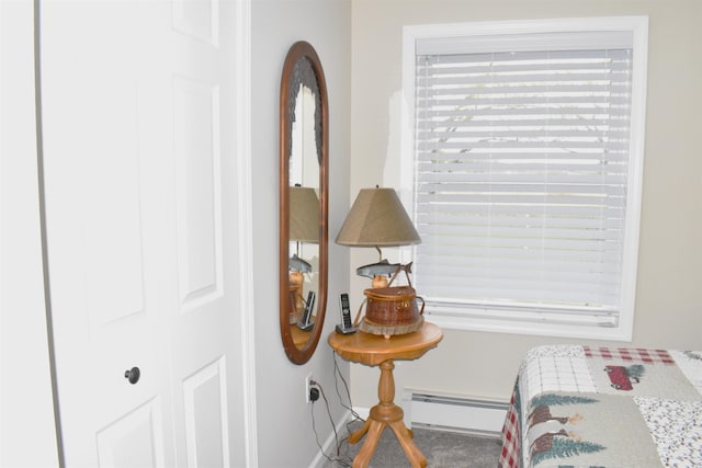 bedroom with baseboards and a baseboard heating unit