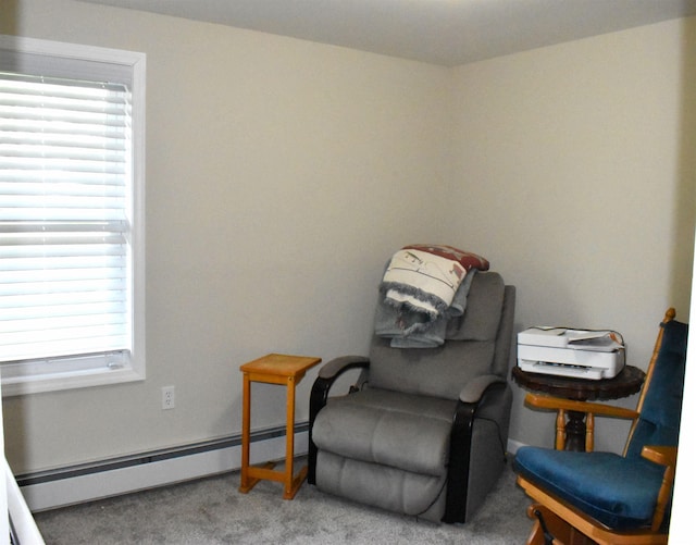 living area featuring a healthy amount of sunlight, a baseboard radiator, and carpet