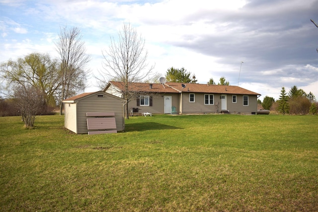back of property featuring a yard, an outdoor structure, entry steps, and a storage unit