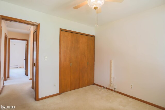 2428 Irma St, Warren, MI 48092 - unfurnished bedroom featuring baseboards, baseboard heating, a closet, and light colored carpet