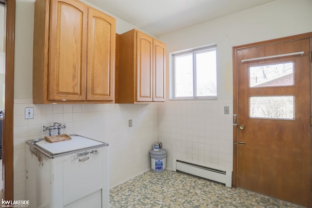 2428 Irma St, Warren, MI 48092 - laundry area featuring a sink, a baseboard heating unit, tile patterned floors, and tile walls