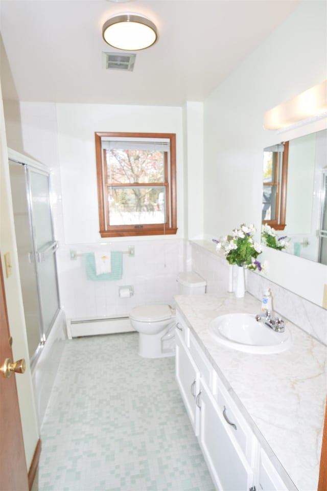 full bath featuring wainscoting, vanity, toilet, a baseboard radiator, and visible vents