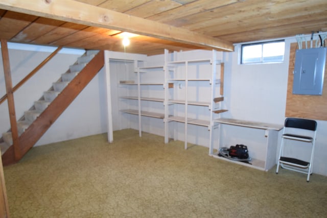 basement featuring wood ceiling, electric panel, stairs, and carpet floors