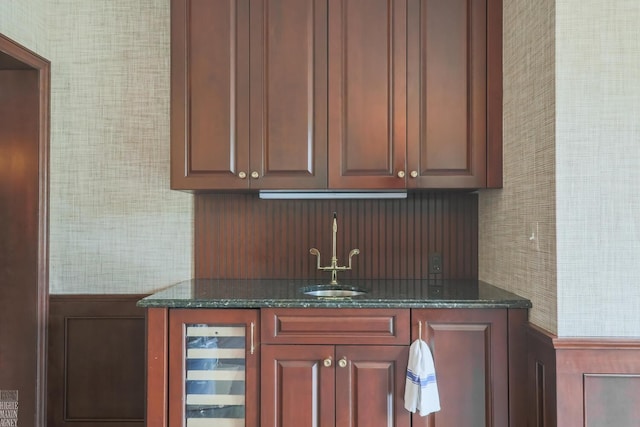 bar featuring beverage cooler, a sink, and indoor wet bar