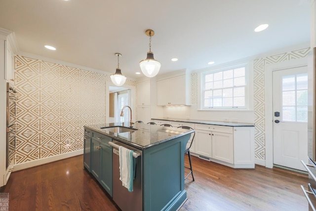 kitchen with stainless steel dishwasher, a sink, and plenty of natural light