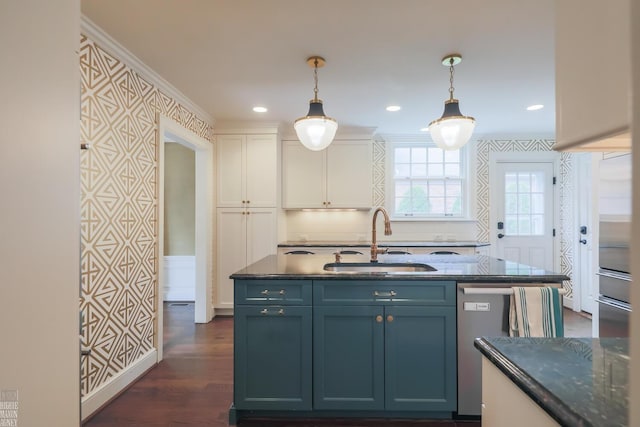 kitchen with hanging light fixtures, a sink, white cabinets, dark wood-style floors, and dark stone counters