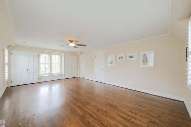 unfurnished room featuring baseboards, ceiling fan, and wood finished floors