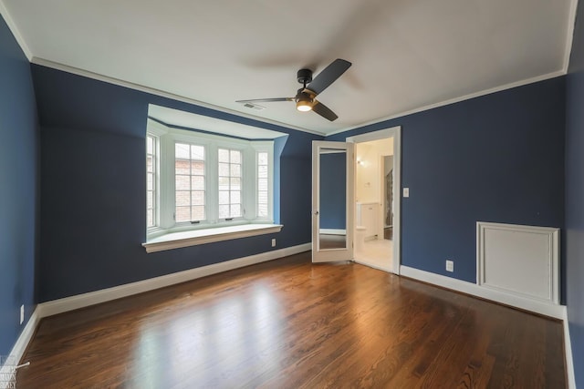 interior space featuring baseboards, ornamental molding, a ceiling fan, and visible vents
