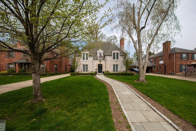 view of front of house featuring a front lawn and a chimney