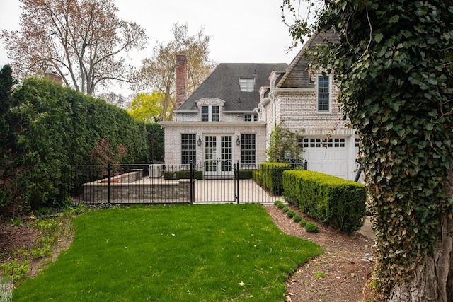 rear view of property featuring french doors, fence, a chimney, and a lawn