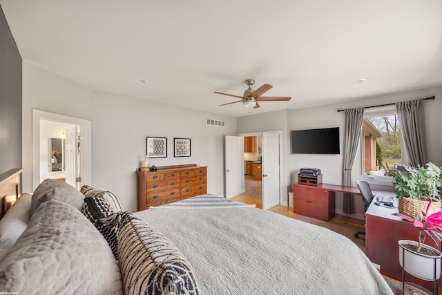 bedroom featuring light wood-style floors, ceiling fan, and visible vents