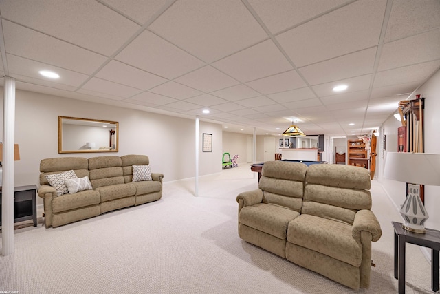living room with carpet floors, recessed lighting, a paneled ceiling, and baseboards