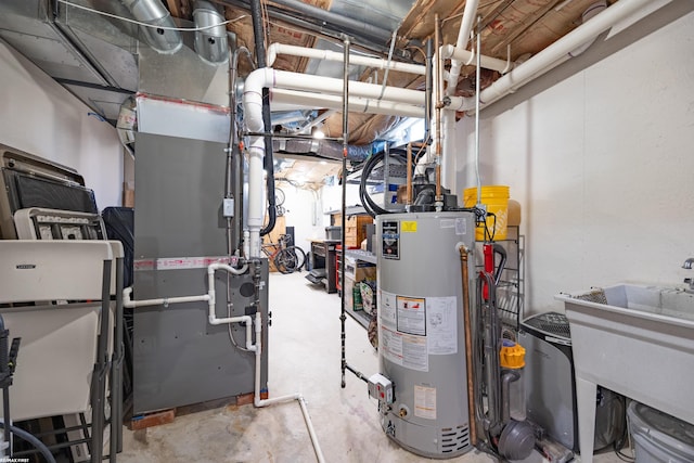 utilities featuring a sink, heating unit, and gas water heater