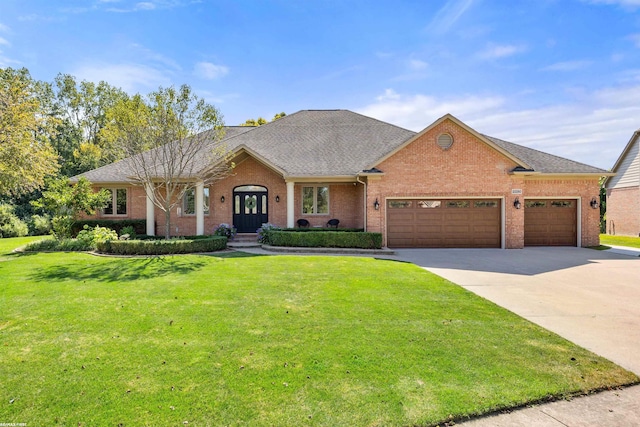 ranch-style house featuring a front lawn, brick siding, a shingled roof, an attached garage, and driveway