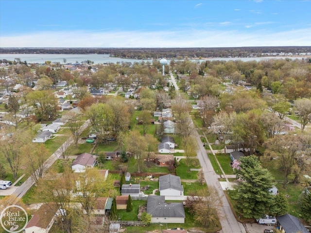 drone / aerial view with a water view and a residential view