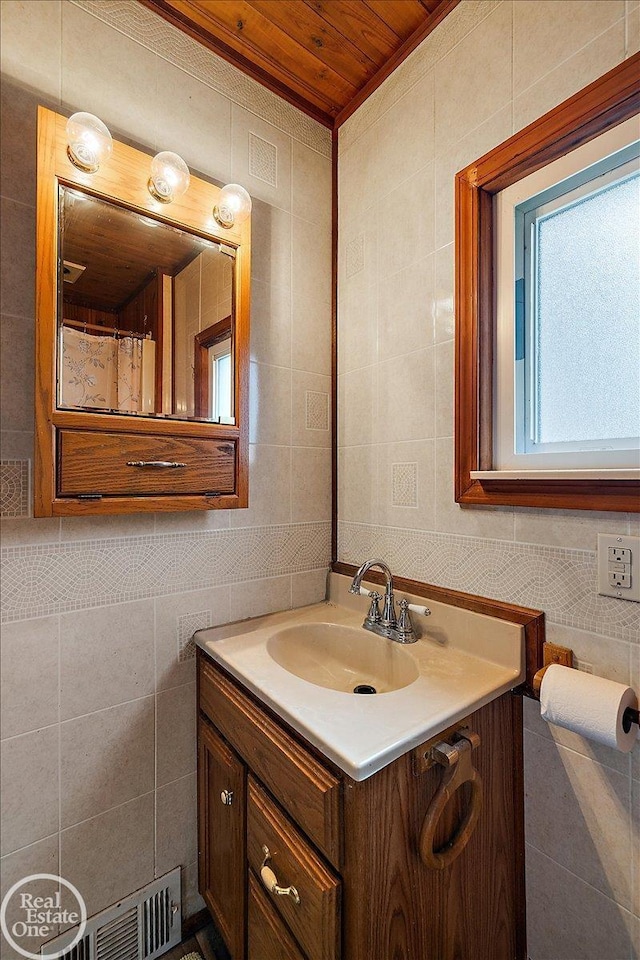bathroom featuring tile walls, wood ceiling, visible vents, and vanity