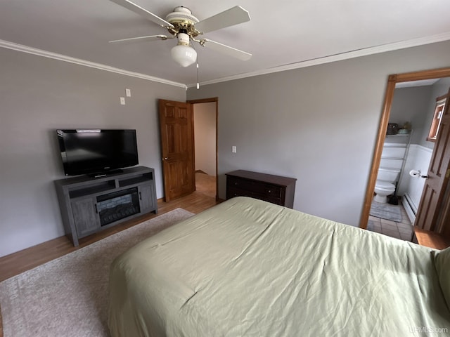 bedroom featuring crown molding, a ceiling fan, connected bathroom, and a baseboard radiator