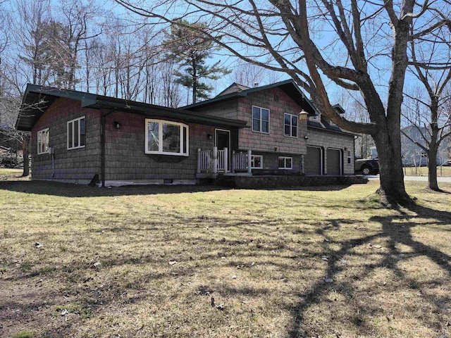 tri-level home with a front yard and a garage