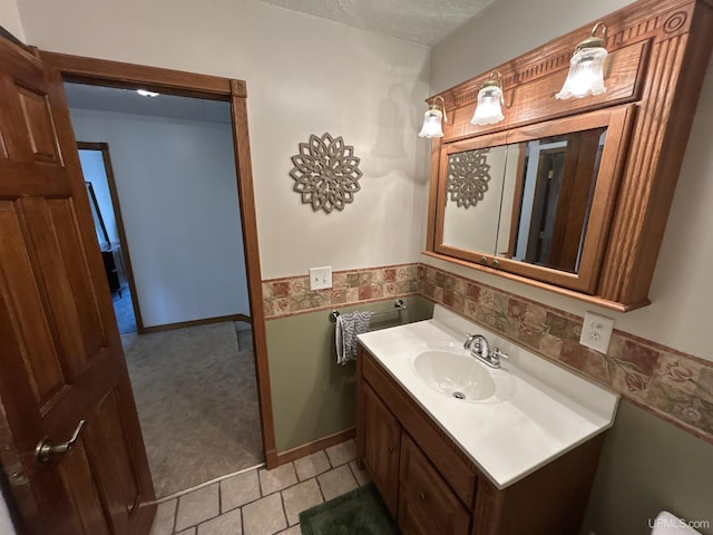 bathroom with vanity and a textured ceiling
