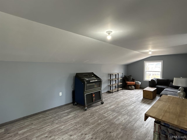 bonus room featuring baseboards, vaulted ceiling, and wood finished floors