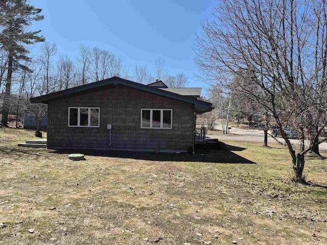 view of side of property with a lawn