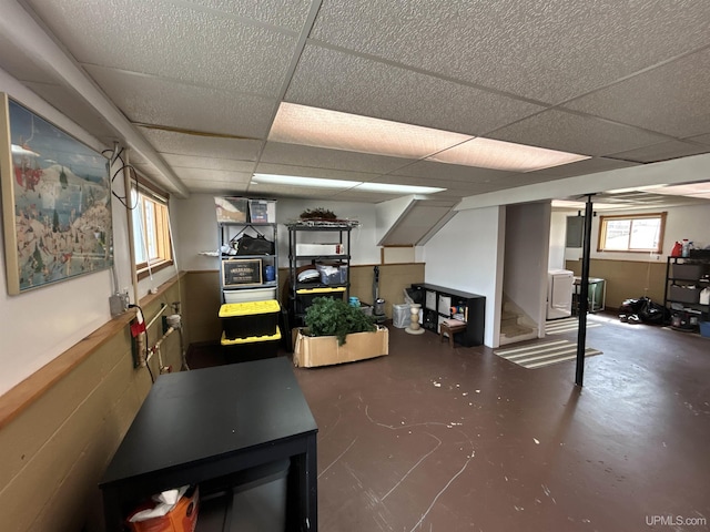 basement featuring stairway and a drop ceiling