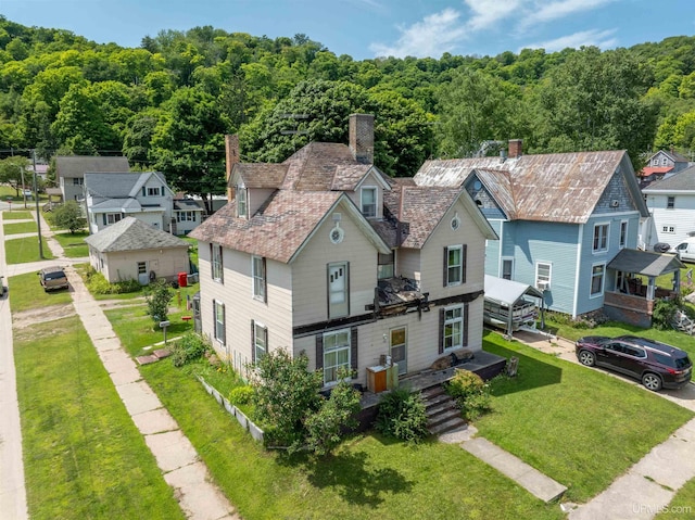 birds eye view of property with a wooded view and a residential view